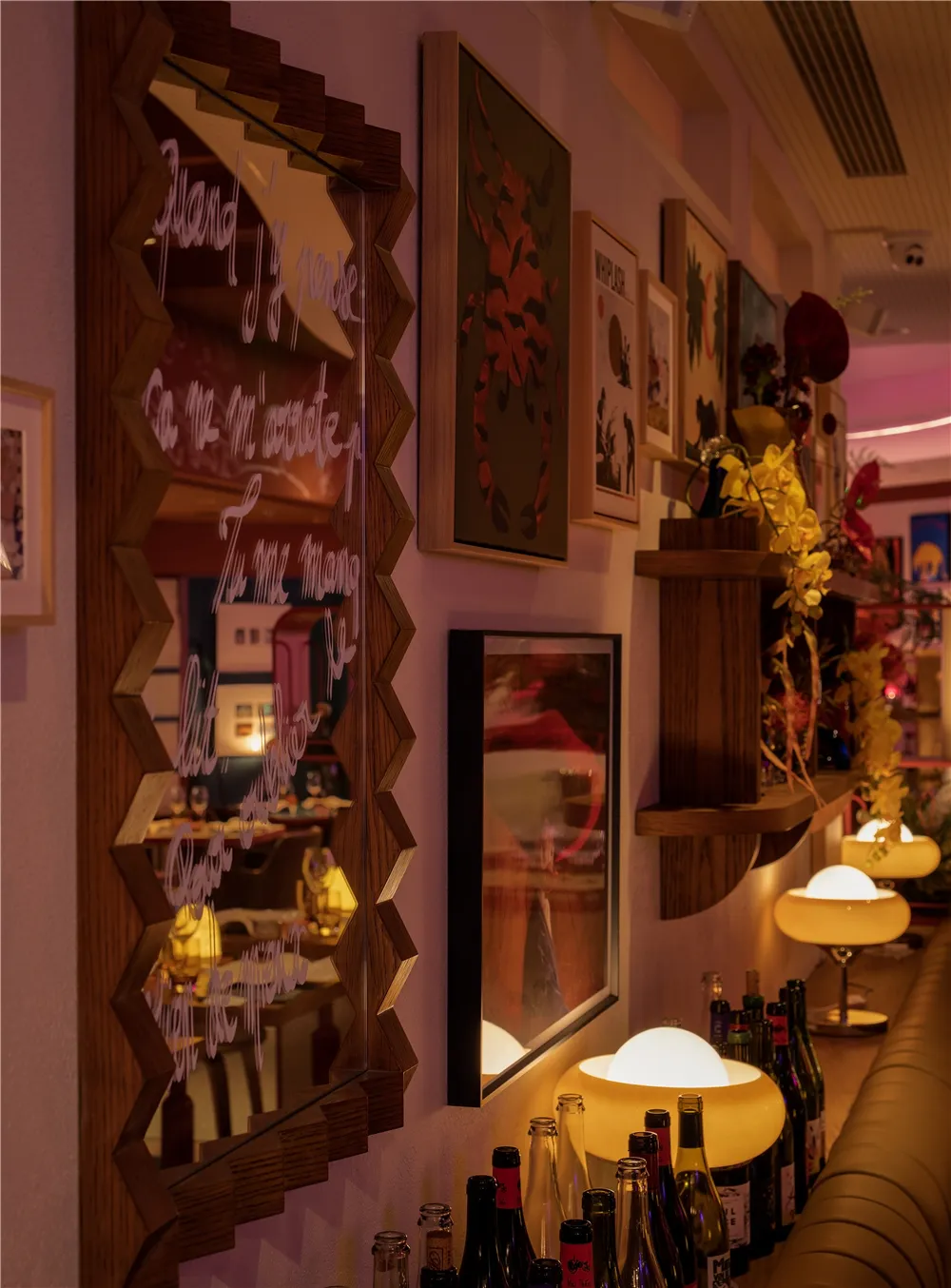 Cozy restaurant bar with a mirror on the wall reflecting the surroundings, bottles on the bar, and a warm atmosphere