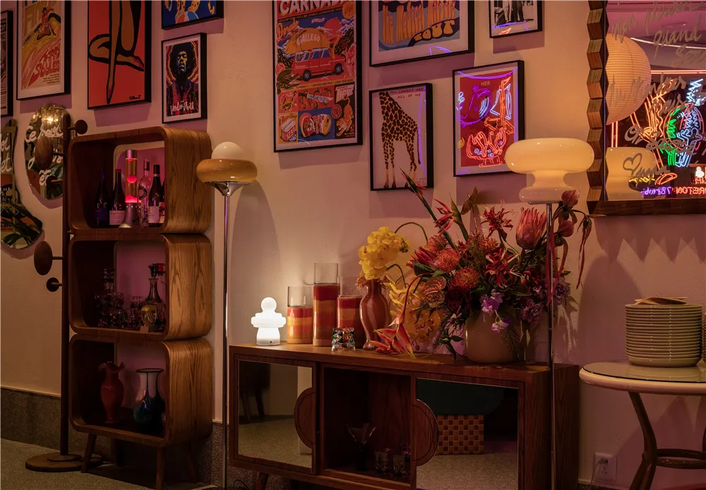 Cozy interior space with a wooden table, vases, a chair, and a potted plant, featuring a focus on artistic expression through object arrangement