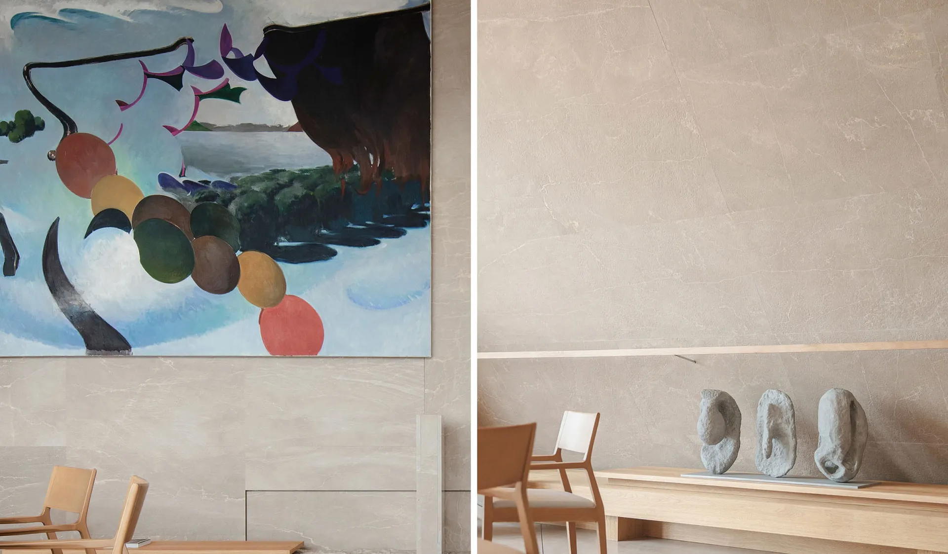 A modern living space with a large painting on the wall, two chairs, and a dining table, featuring a combination of wood and stone elements