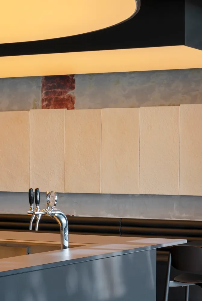 Modern kitchen with metal faucets and bottles, designed for cooking and food preparation