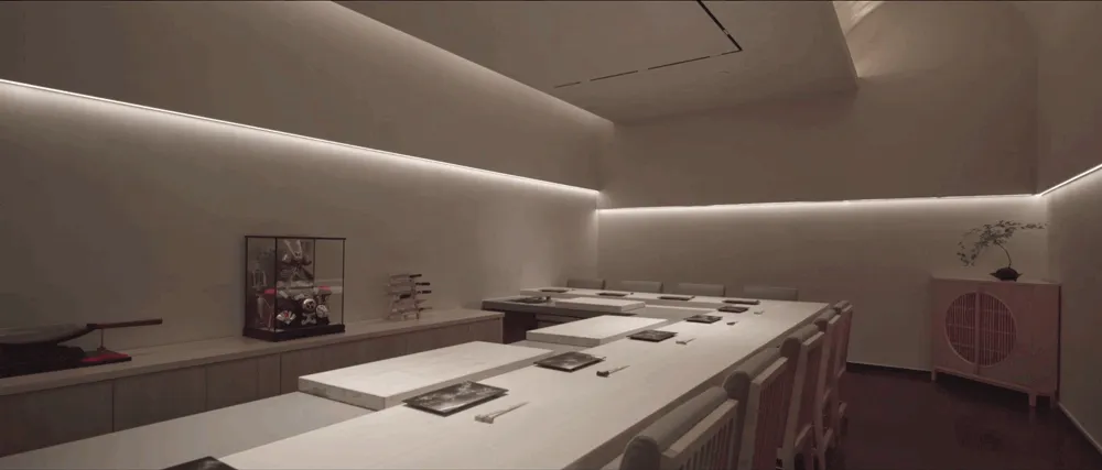 Empty restaurant dining area with white walls, tables, and chairs, in need of decoration