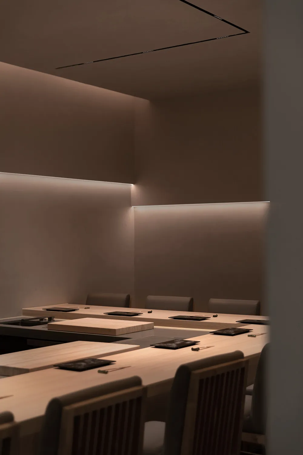 A well-lit conference room with wooden tables and chairs arranged in rows, suitable for business events or gatherings