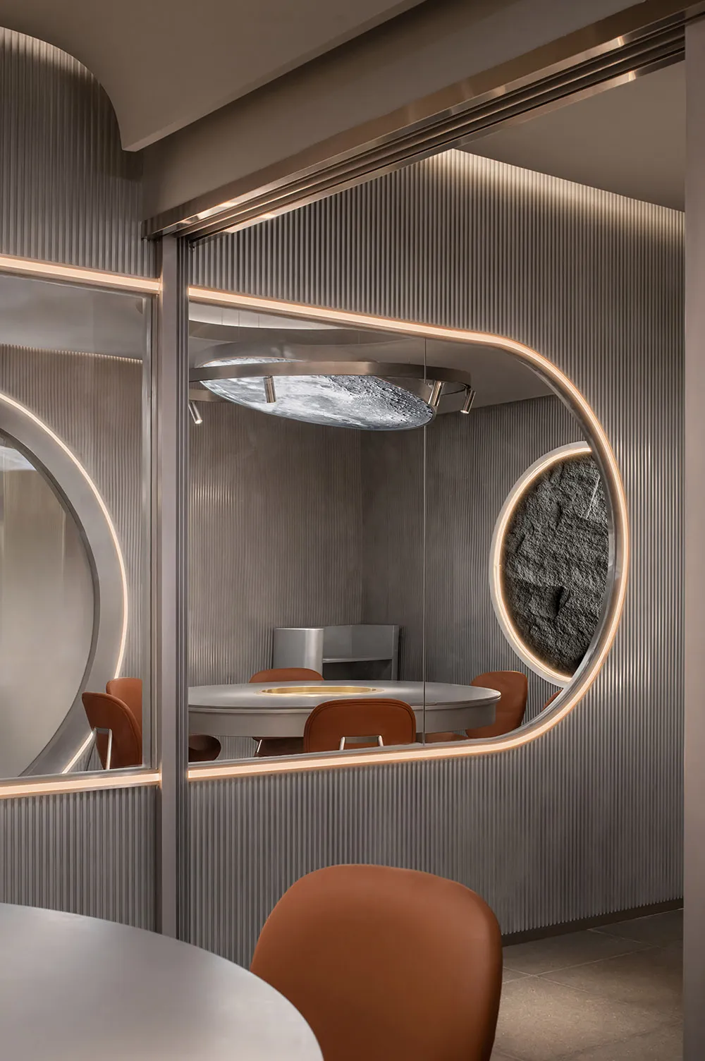 A modern dining area with a round wooden table surrounded by four metal chairs, creating an inviting atmosphere