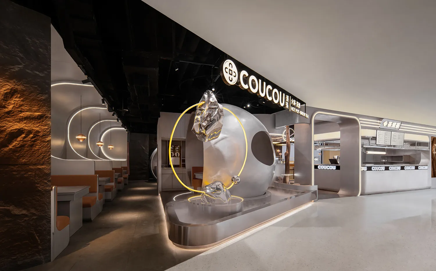 A modern showroom with a large glass sphere as its centerpiece, surrounded by chairs and dining tables, with a clean and contemporary feel