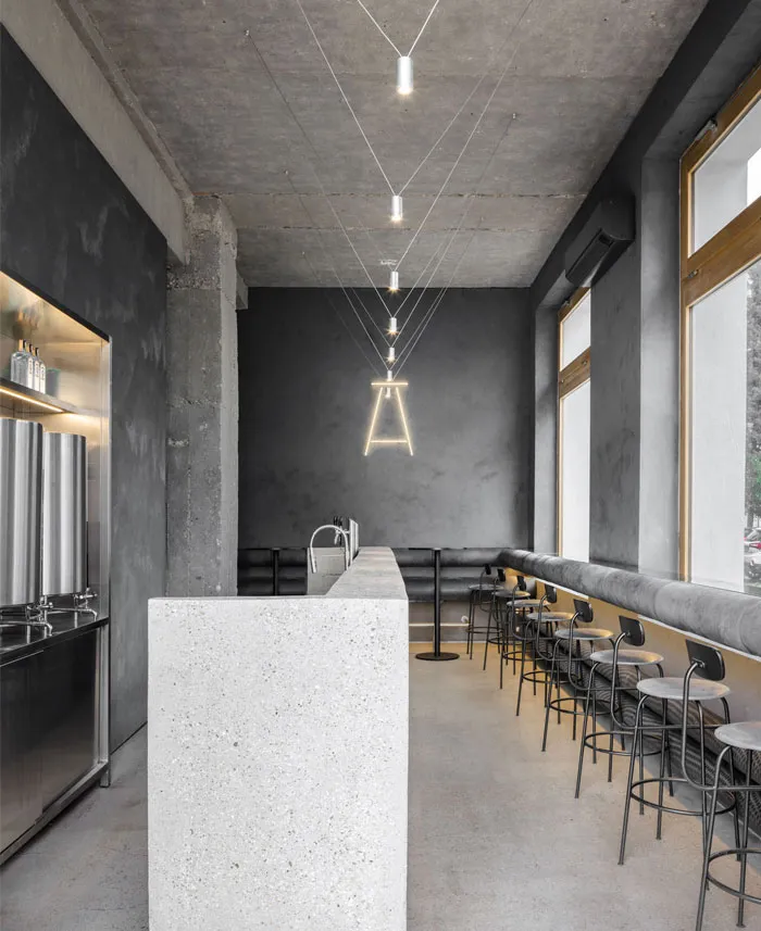 Modern restaurant interior with a marble countertop, chairs, and a sophisticated atmosphere