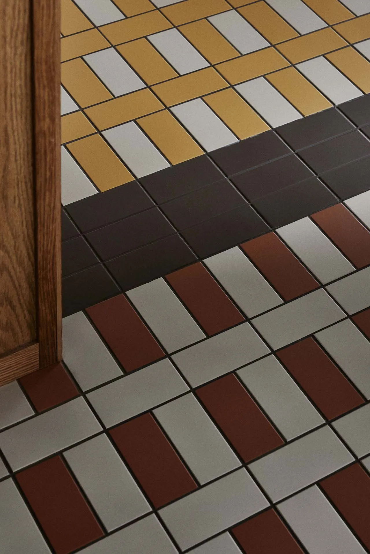 A well-lit room with a checkered floor made of ceramic tiles, adding a decorative touch to the space