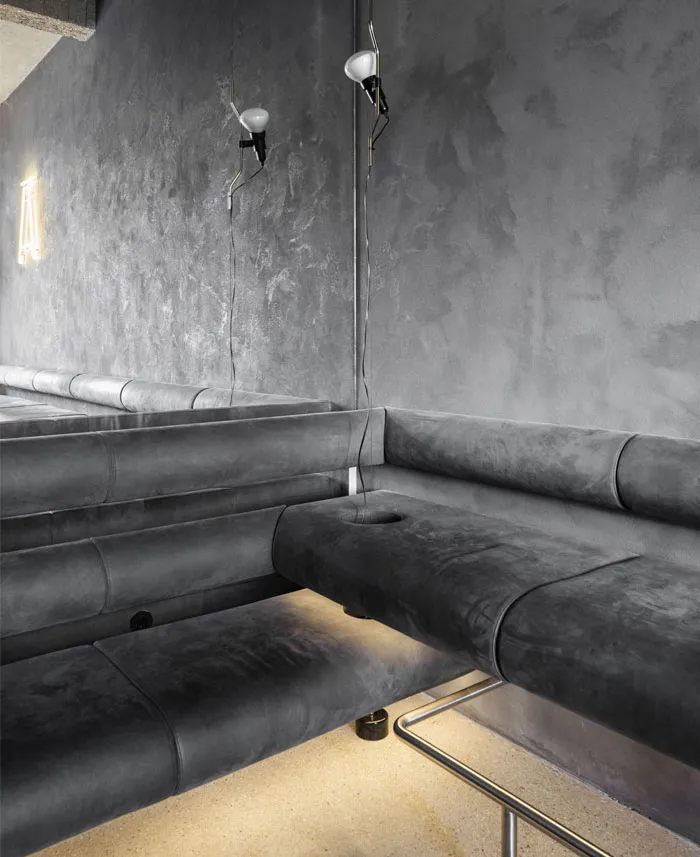 Gray leather couches in a cozy living room with a modern aesthetic