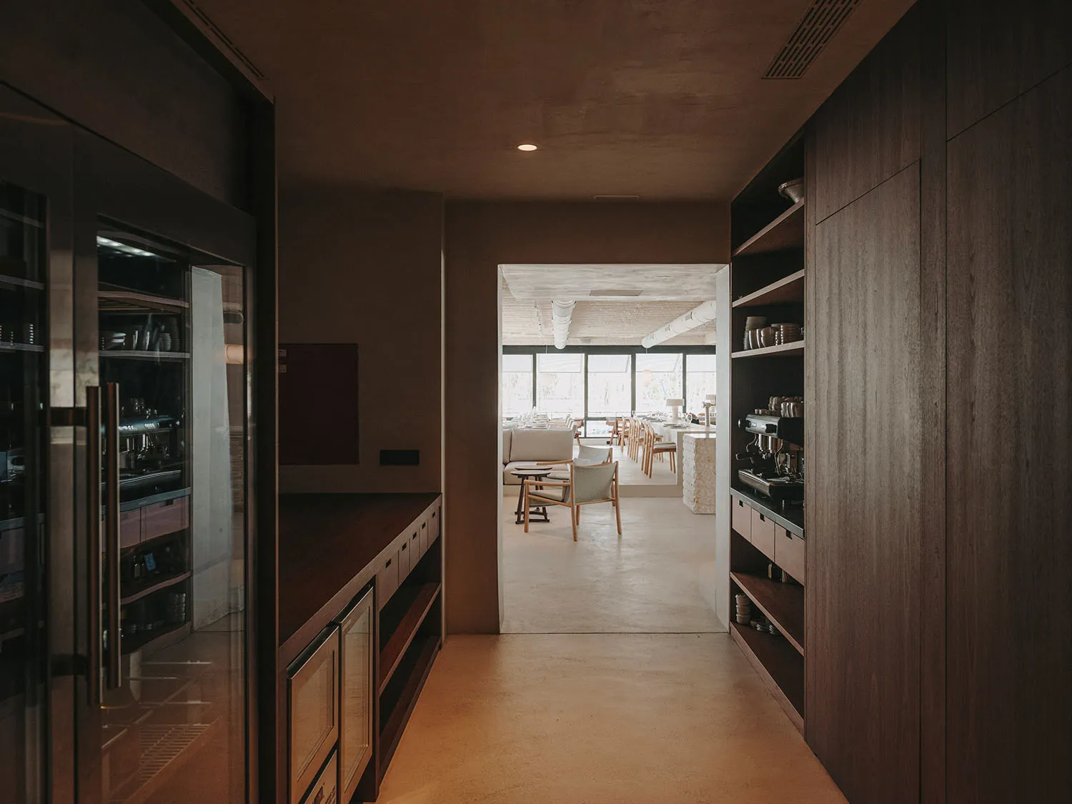Cozy open kitchen with wooden cabinets, a dining table, and chairs, creating a warm and inviting atmosphere