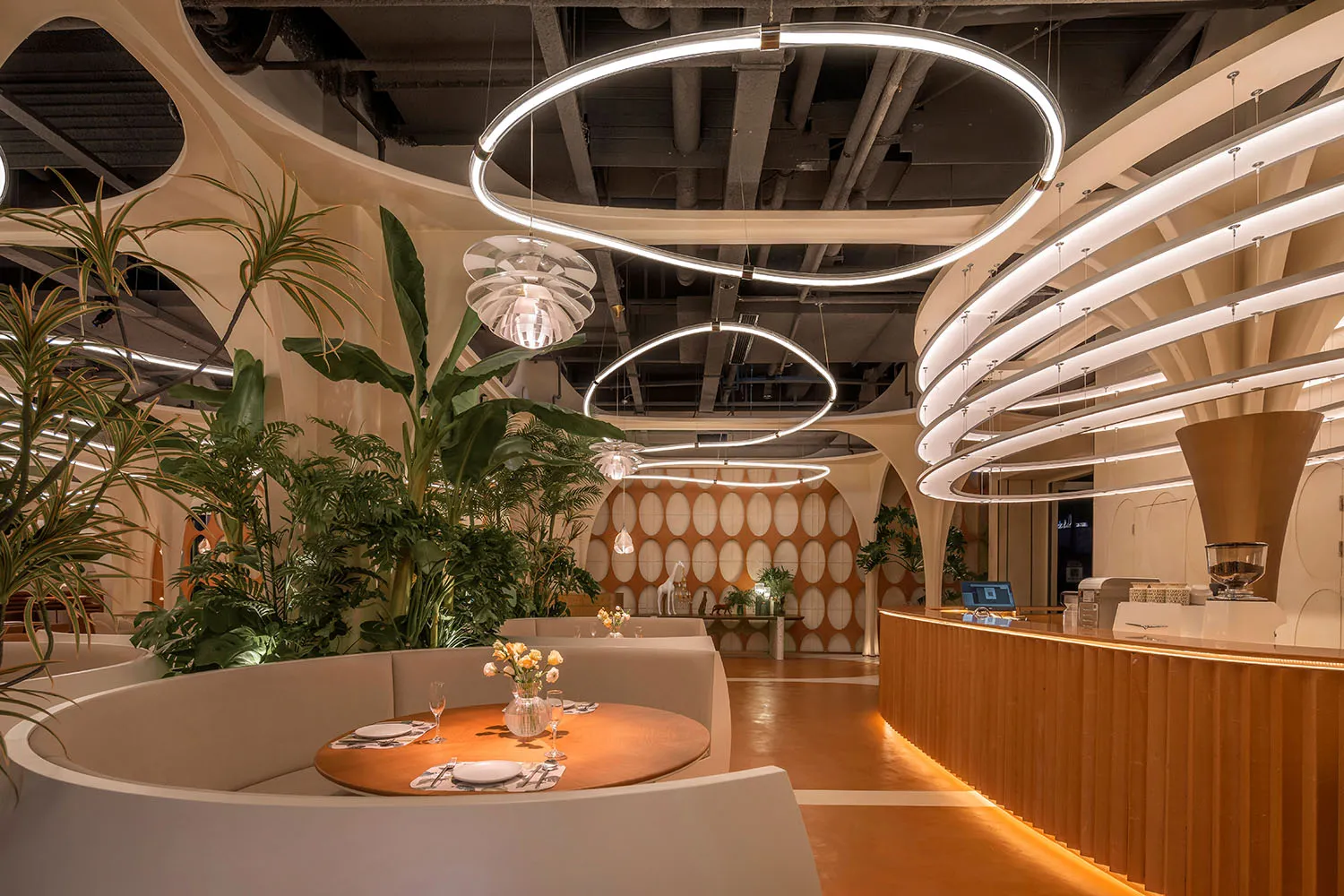 Modern restaurant interior with wooden paneling, tables, chairs, and potted plants, creating a warm and inviting atmosphere