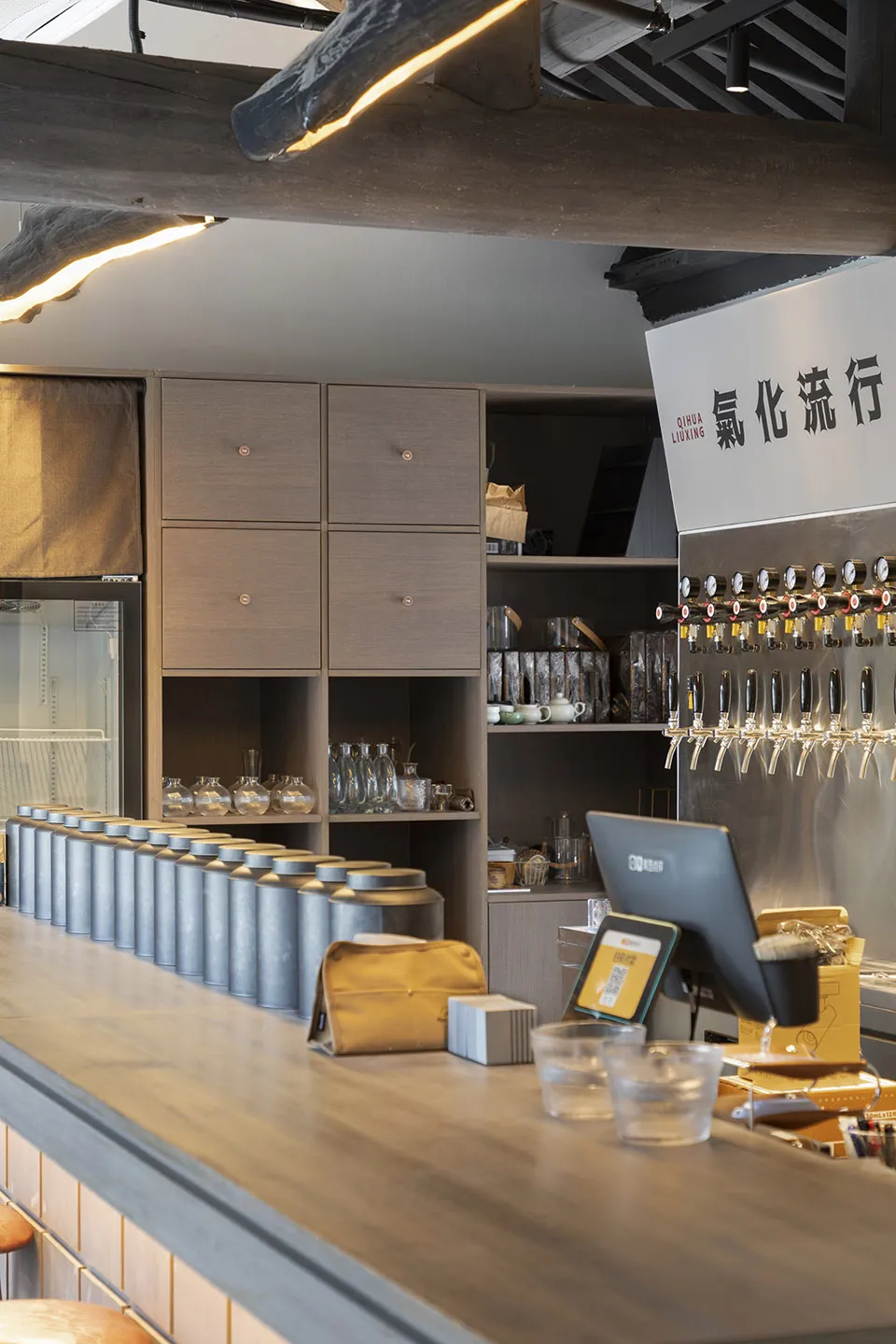 A lively Asian restaurant bar with numerous beer taps and bottles, and scattered cups, inviting customers to enjoy a variety of drinks