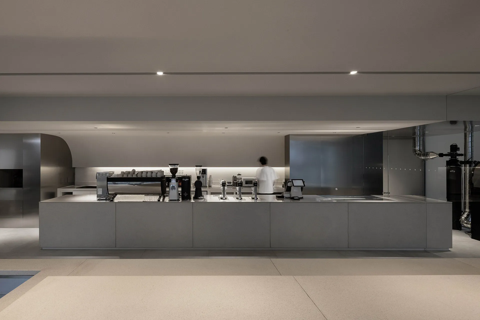 Industrial kitchen with appliances, clean and organized, functional layout, and multiple cups for serving