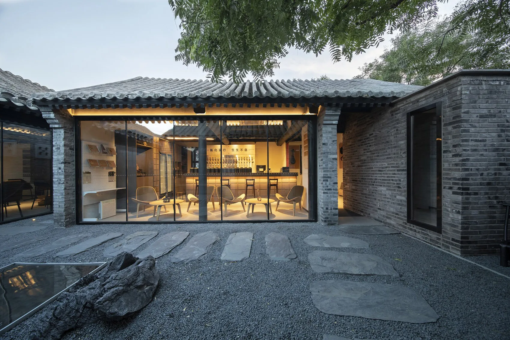 A modern Asian restaurant with a large dining area featuring multiple tables and chairs, creating an inviting and comfortable atmosphere