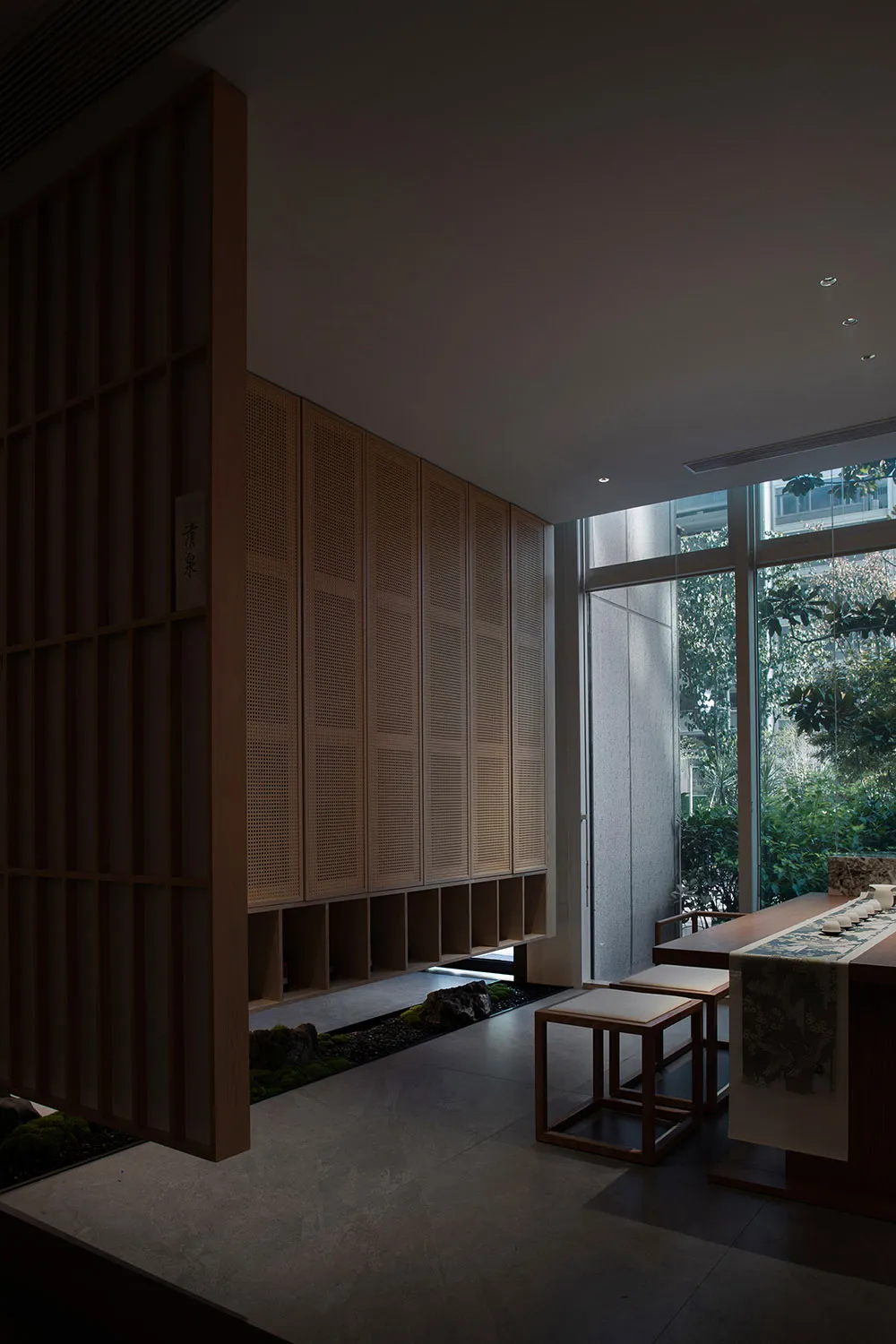 Cozy modern dining space with a table and chairs, a couch, and a potted plant, set against a clean and minimalist background