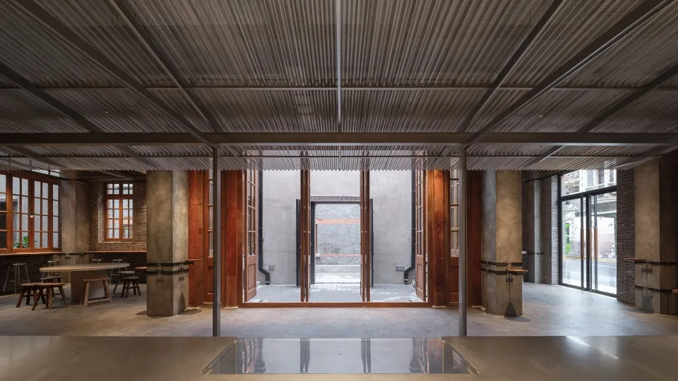 A spacious interior space with wooden doors, brown in color, and multiple sets of doors, including double doors and smaller doors, creating a warm and inviting atmosphere