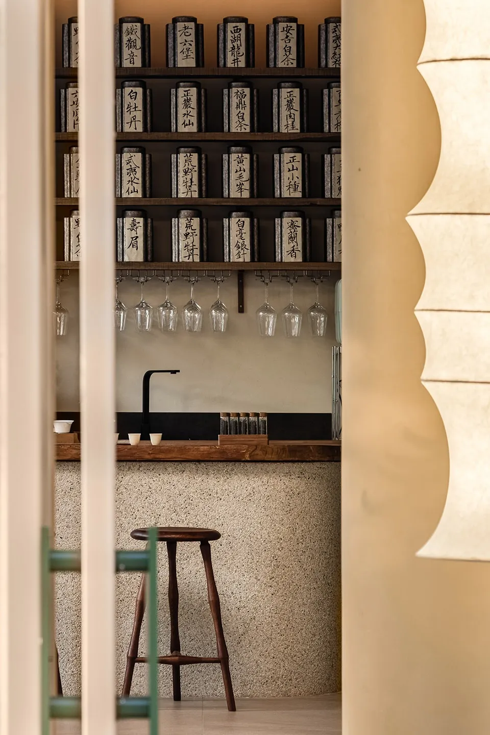 Inviting Asian restaurant interior with a bar area, wine glasses, cups, and bowls, set in a comfortable and welcoming atmosphere