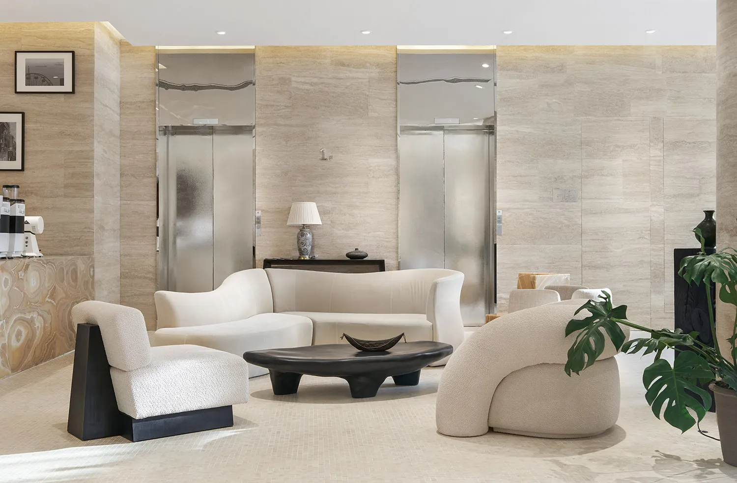 A modern living space with a white couch, carpeted floor, and several chairs, surrounded by potted plants and a vase, creating a comfortable and inviting atmosphere with clean lines and minimalist design elements