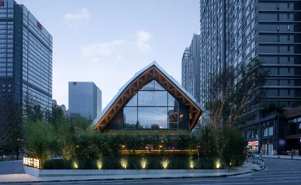 A modern building with a large glass wall that appears to be made of wood, featuring a contemporary and minimalist design with clean lines and high-quality materials