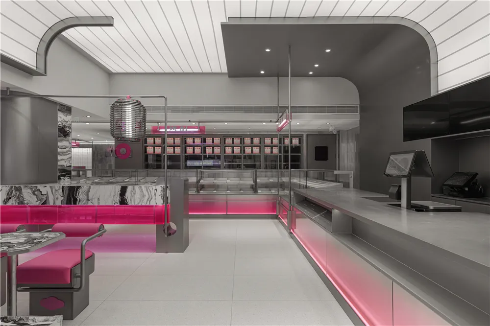 Empty modern restaurant interior with pink walls, chairs, and a welcoming atmosphere