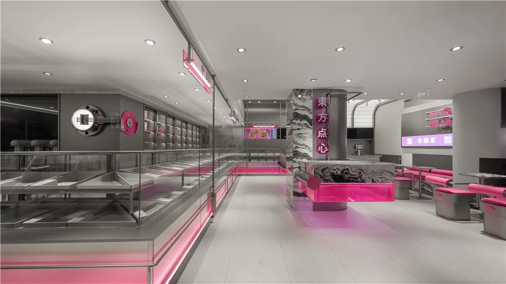 Modern restaurant with a pink and white color scheme, white tile flooring, and ample seating options