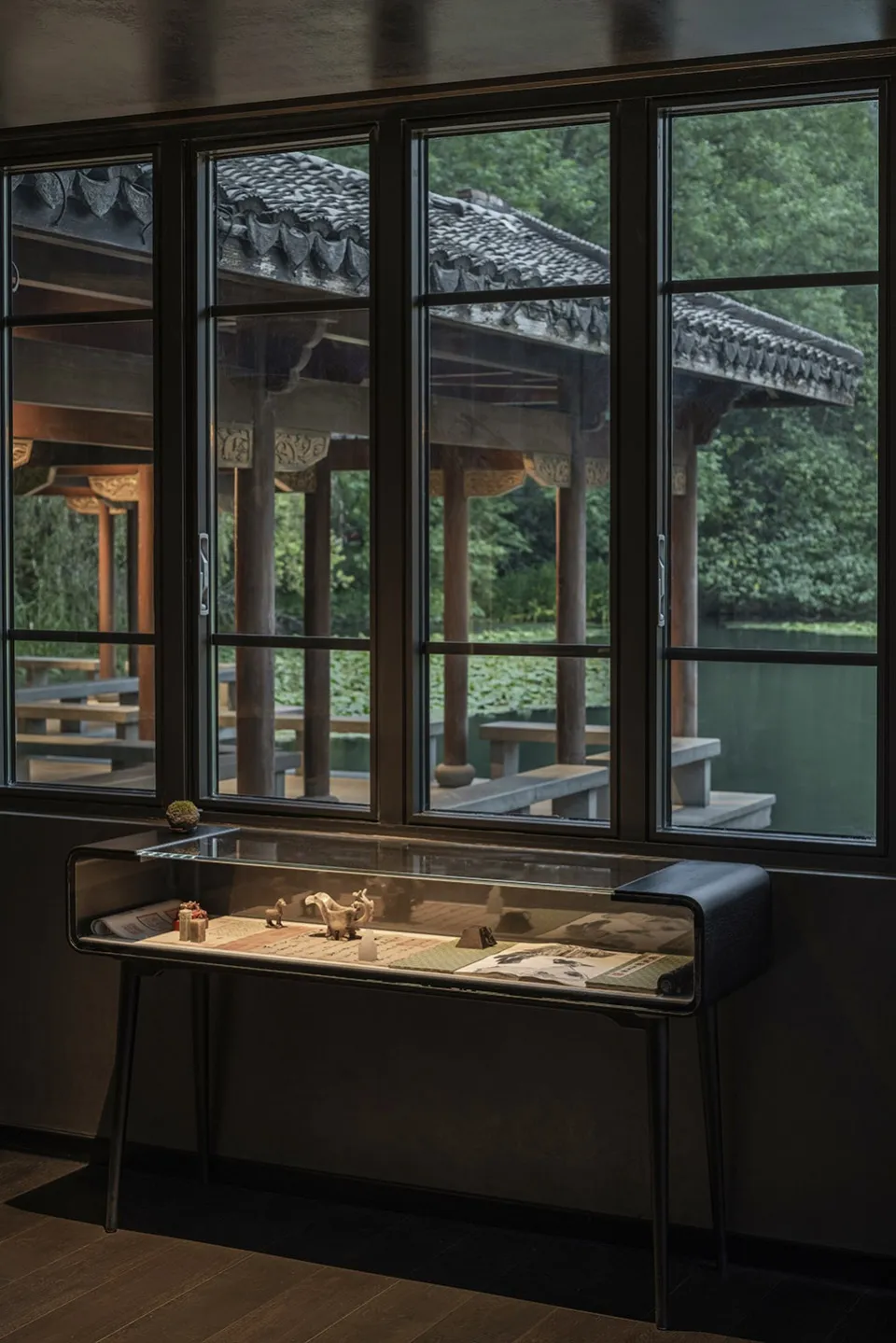 A traditional Asian building with a wooden structure and glass window, featuring cozy benches and a culturally rich interior