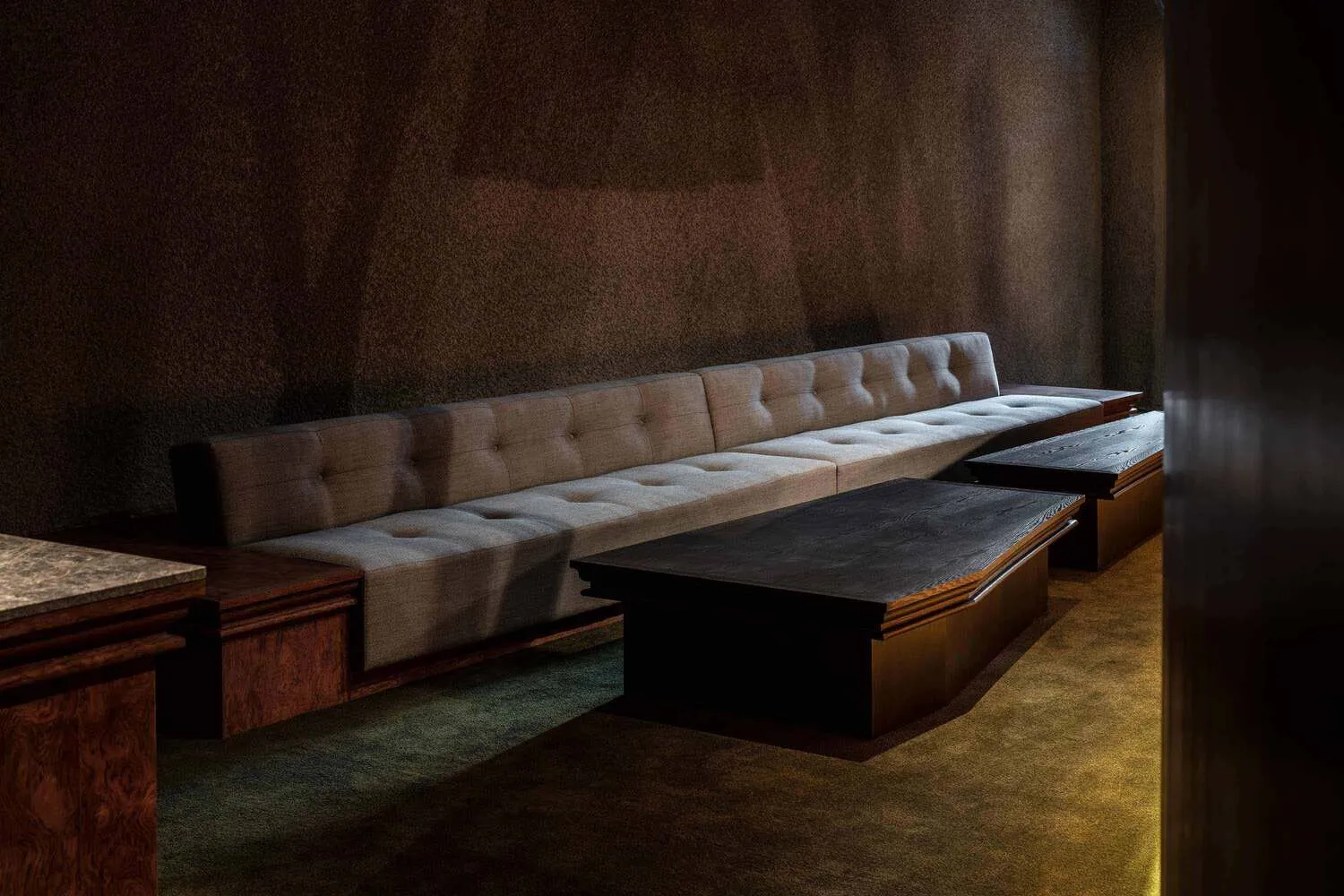 Cozy living space with two couches and two benches, arranged for comfortable seating