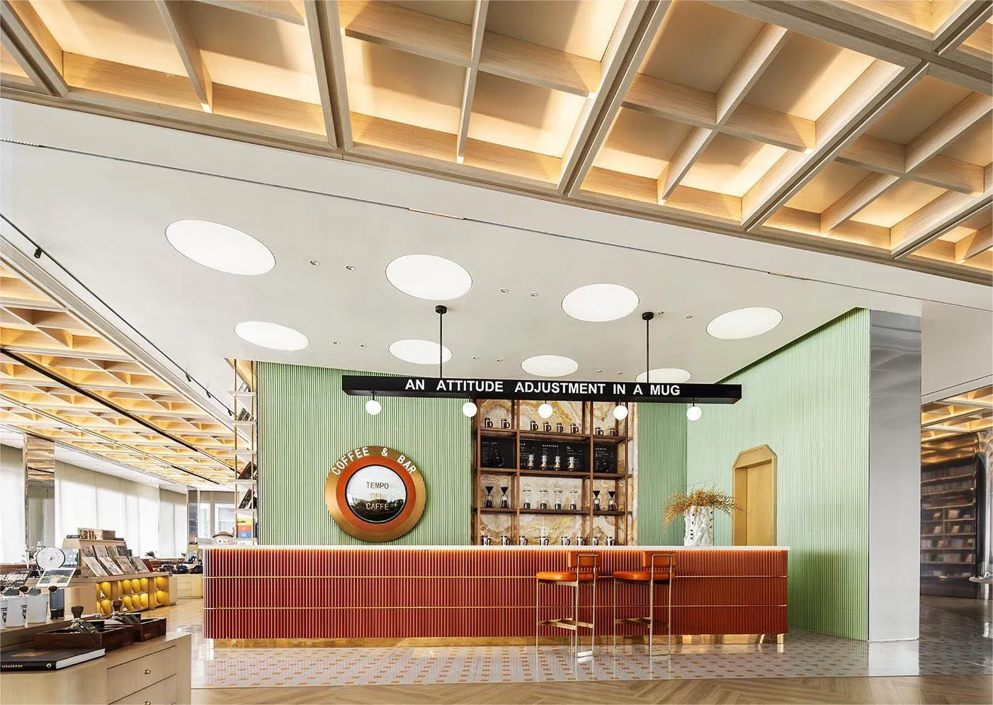 Inviting coffee shop with a bar area featuring a counter and stools, surrounded by comfortable seating and beverage cups