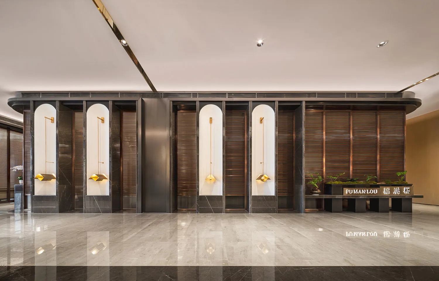 A well-lit lobby area with marble columns, white curtains, and potted plants creating a luxurious atmosphere