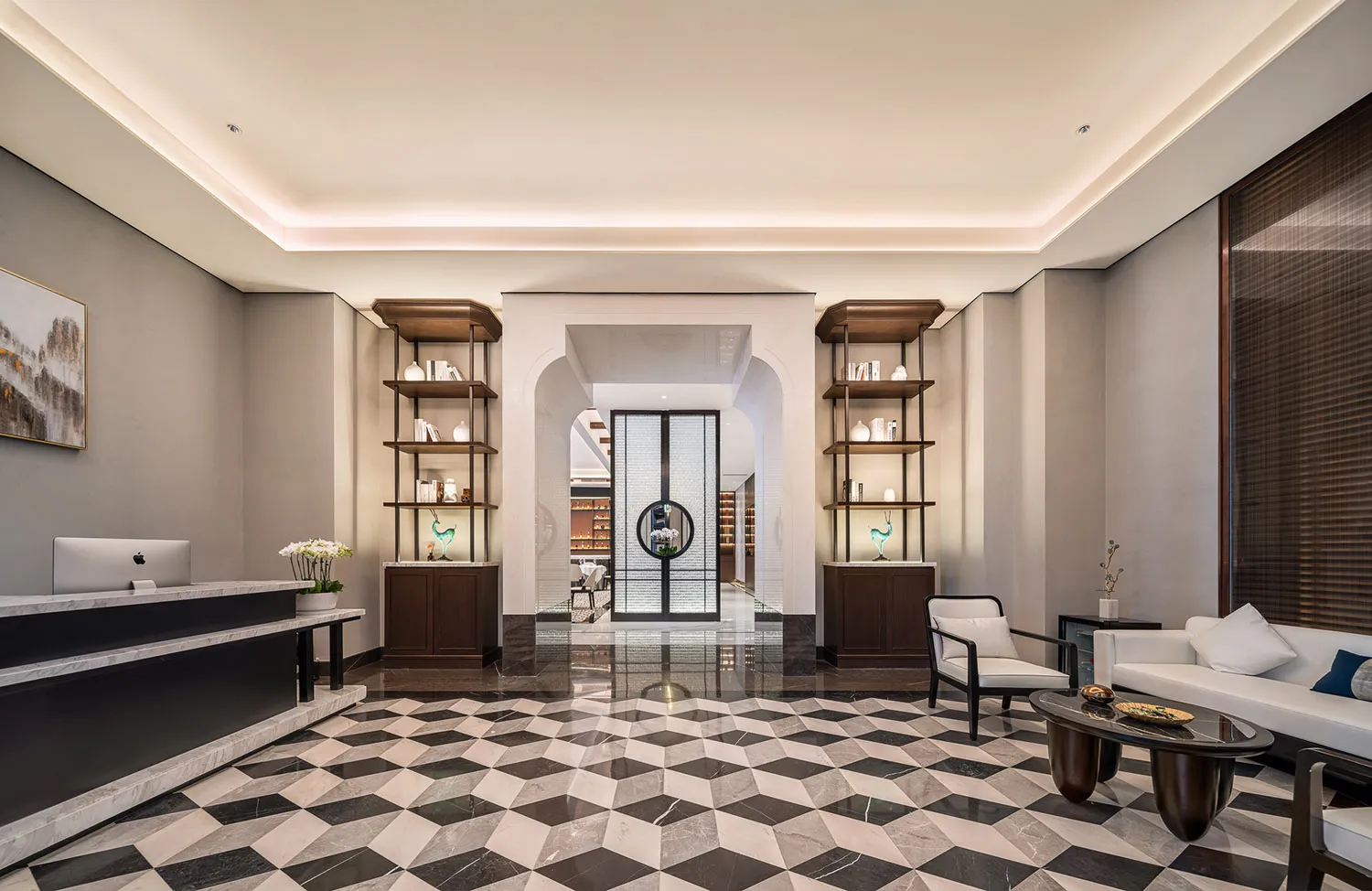 A marble-floored lobby with two chairs and decorative vases, creating a welcoming atmosphere