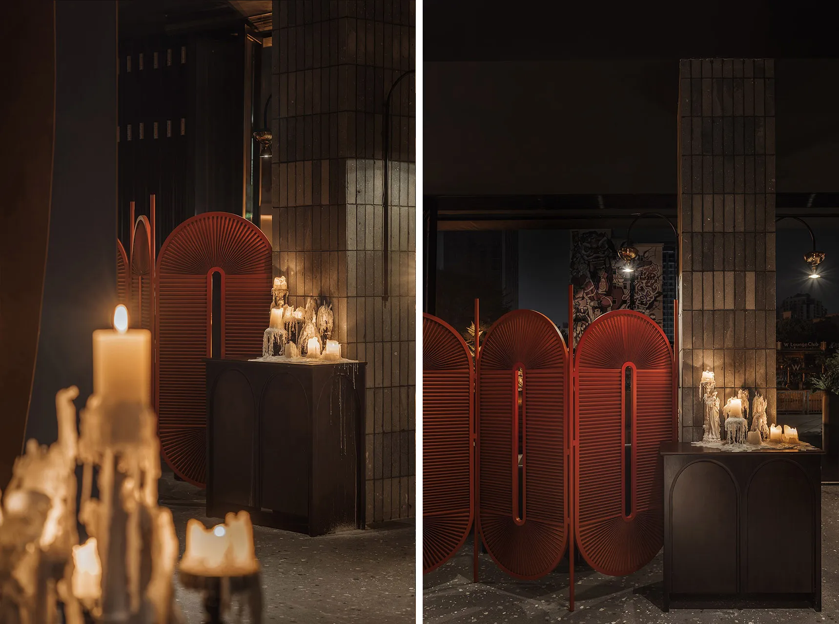 Dimly lit modern space with red accents, candles, and a mix of living and dining areas