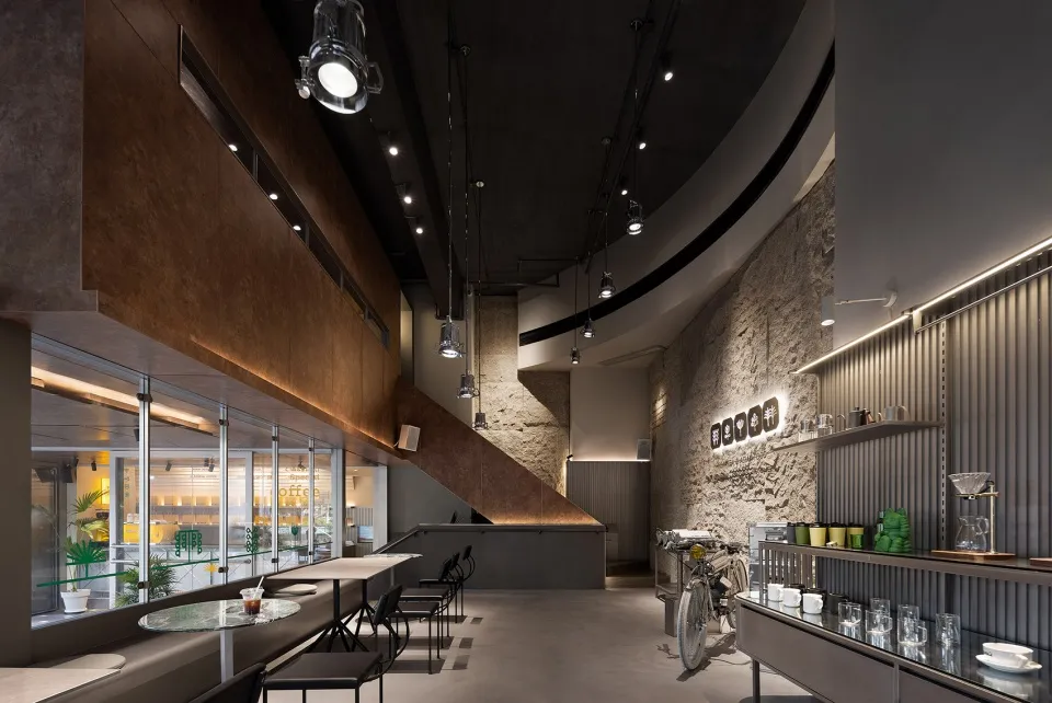 Modern restaurant interior with potted plants, decorative bottles, and vases, set against a contemporary backdrop
