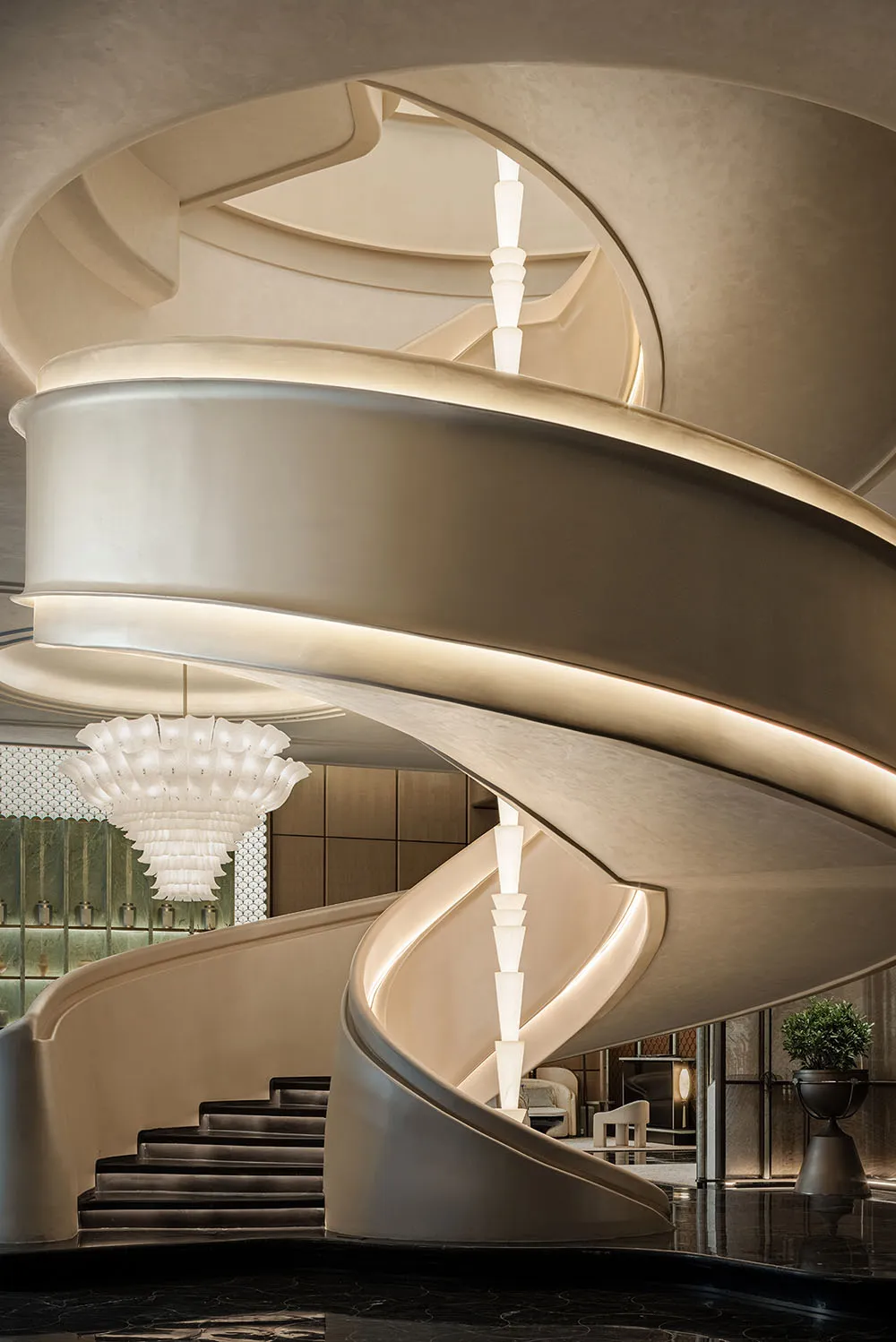 A spiral staircase made of marble in a modern hotel or luxury residence, with a sophisticated and elegant atmosphere