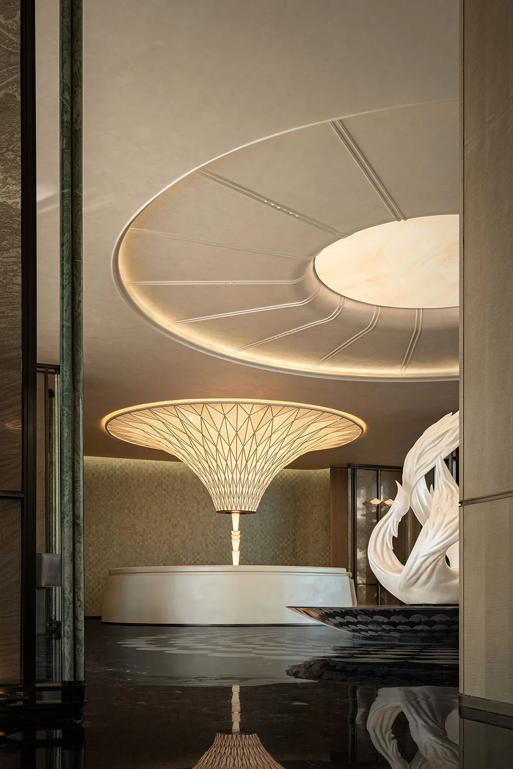 A modern room with a circular sculpture, white and beige walls, and a calm atmosphere, ideal for relaxation or social gatherings