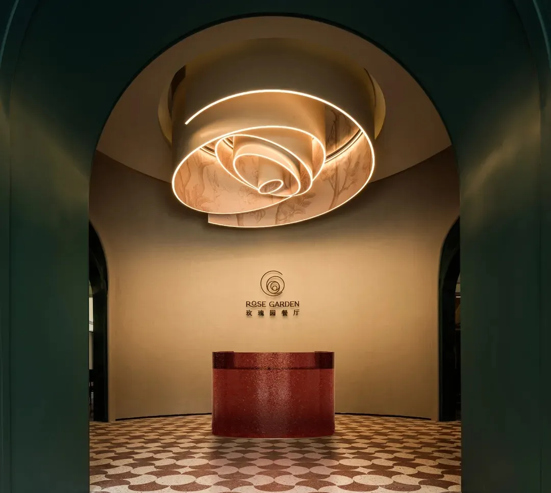 A modern hotel lobby with a red countertop, likely made of marble or granite, in an elegant and inviting atmosphere