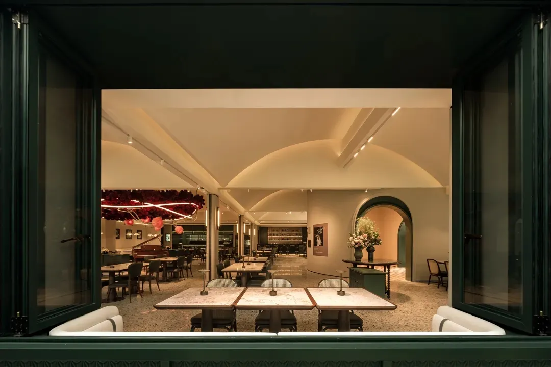 A restaurant dining area with multiple tables and chairs, creating an inviting atmosphere for socializing and enjoying meals together