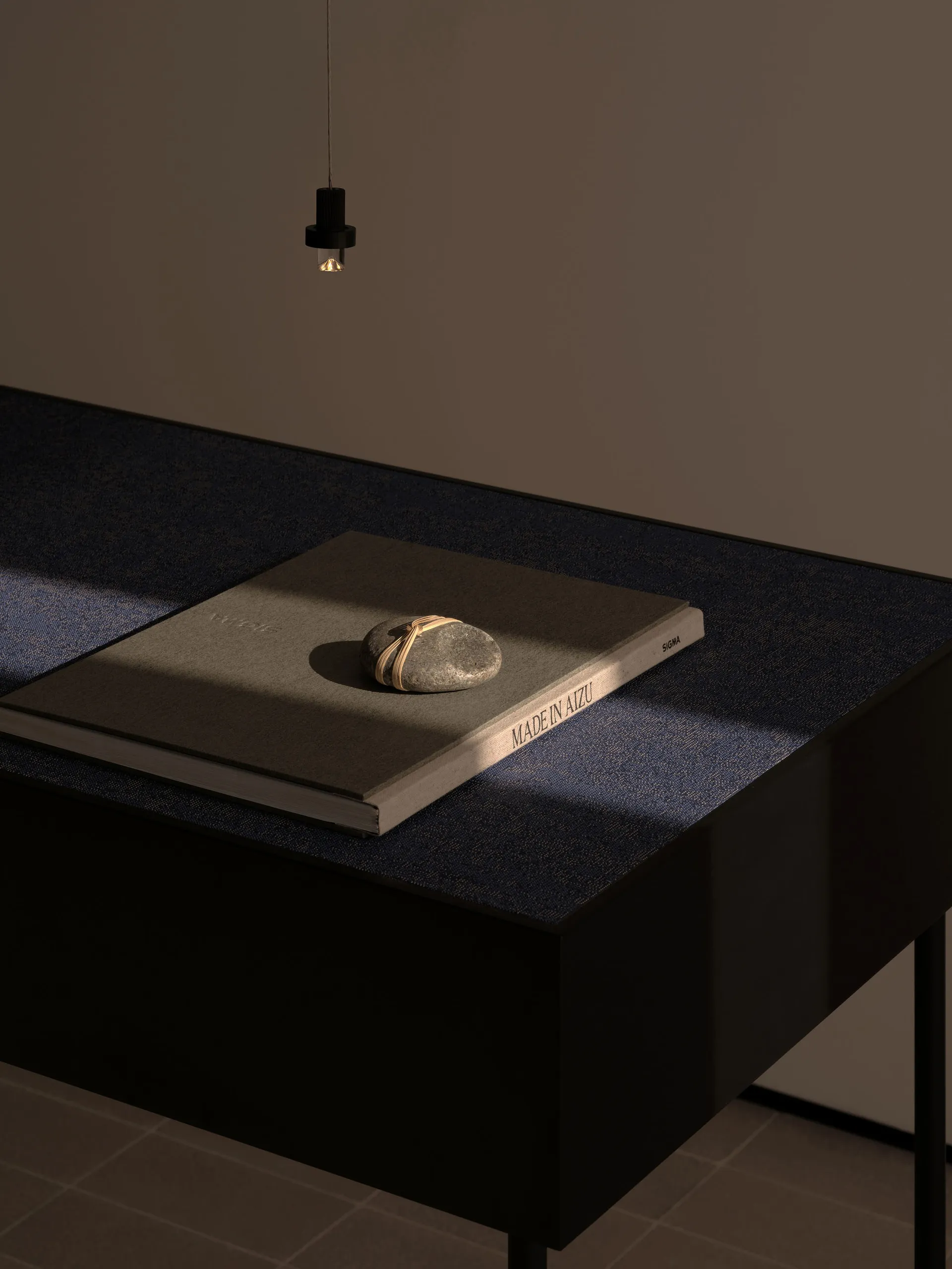 A wooden table with a book on top, in front of a wall, with a calm and organized atmosphere