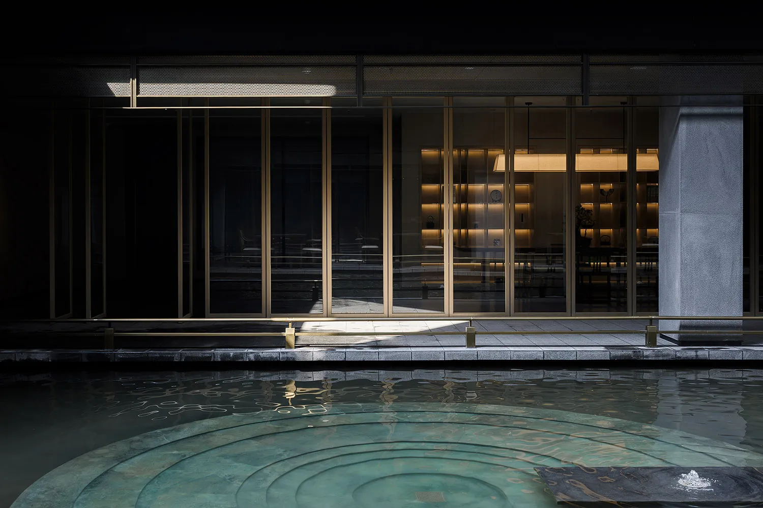 Indoor pool with a circular design, surrounded by chairs and a luxurious atmosphere