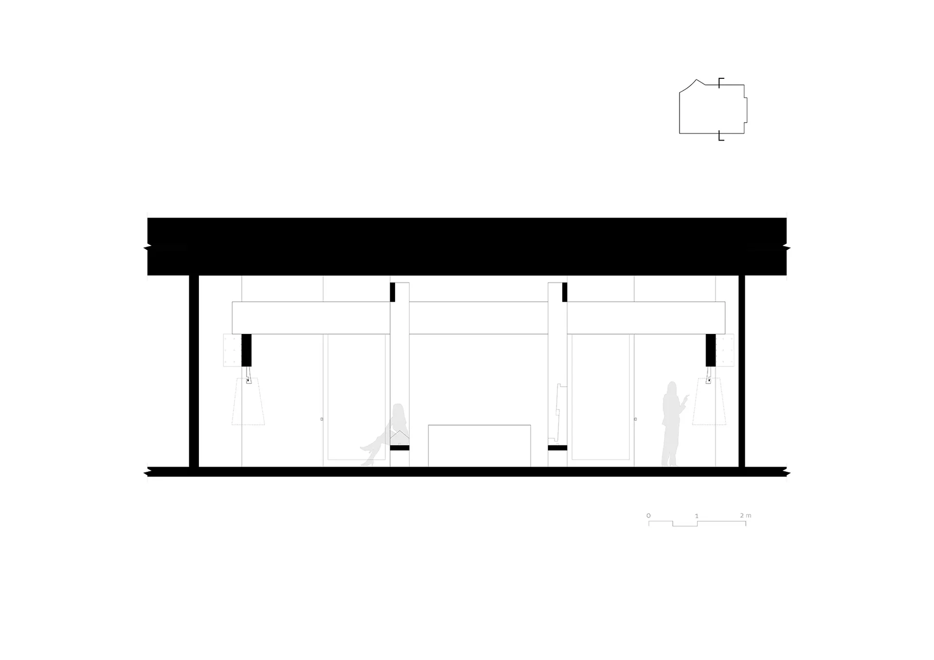 A spacious office space with natural light, featuring three individuals walking around, with a warm and inviting atmosphere