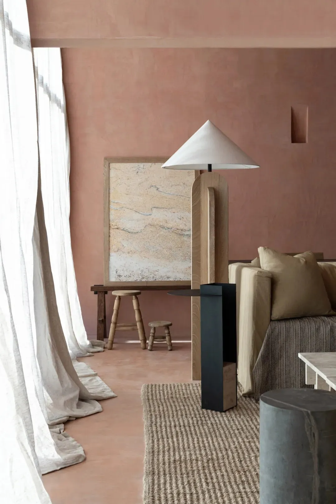Cozy living space with a rug, couch, chair, and lamp, featuring brick walls and warm lighting