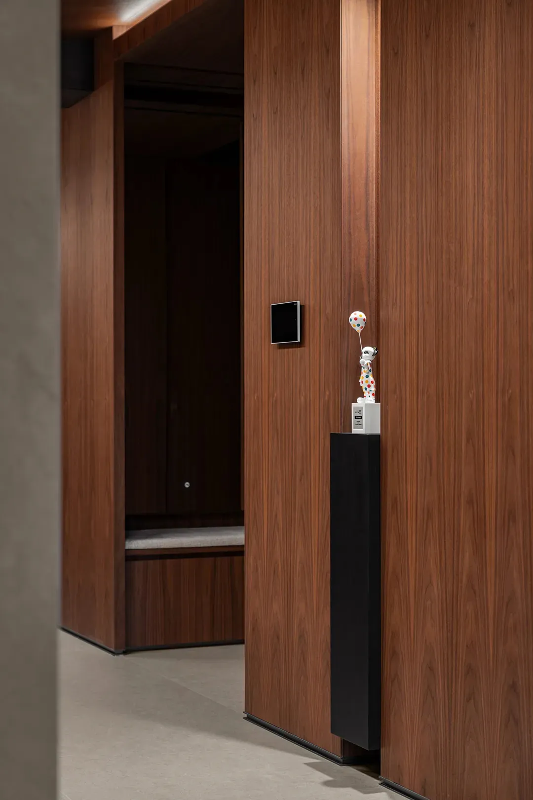 A dark hallway with wooden walls and floors, featuring two doors and a gloomy atmosphere