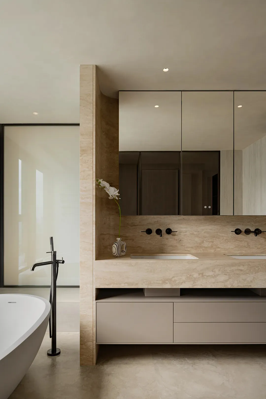 Double sink bathroom with two toilets, mirrors, and a luxurious interior