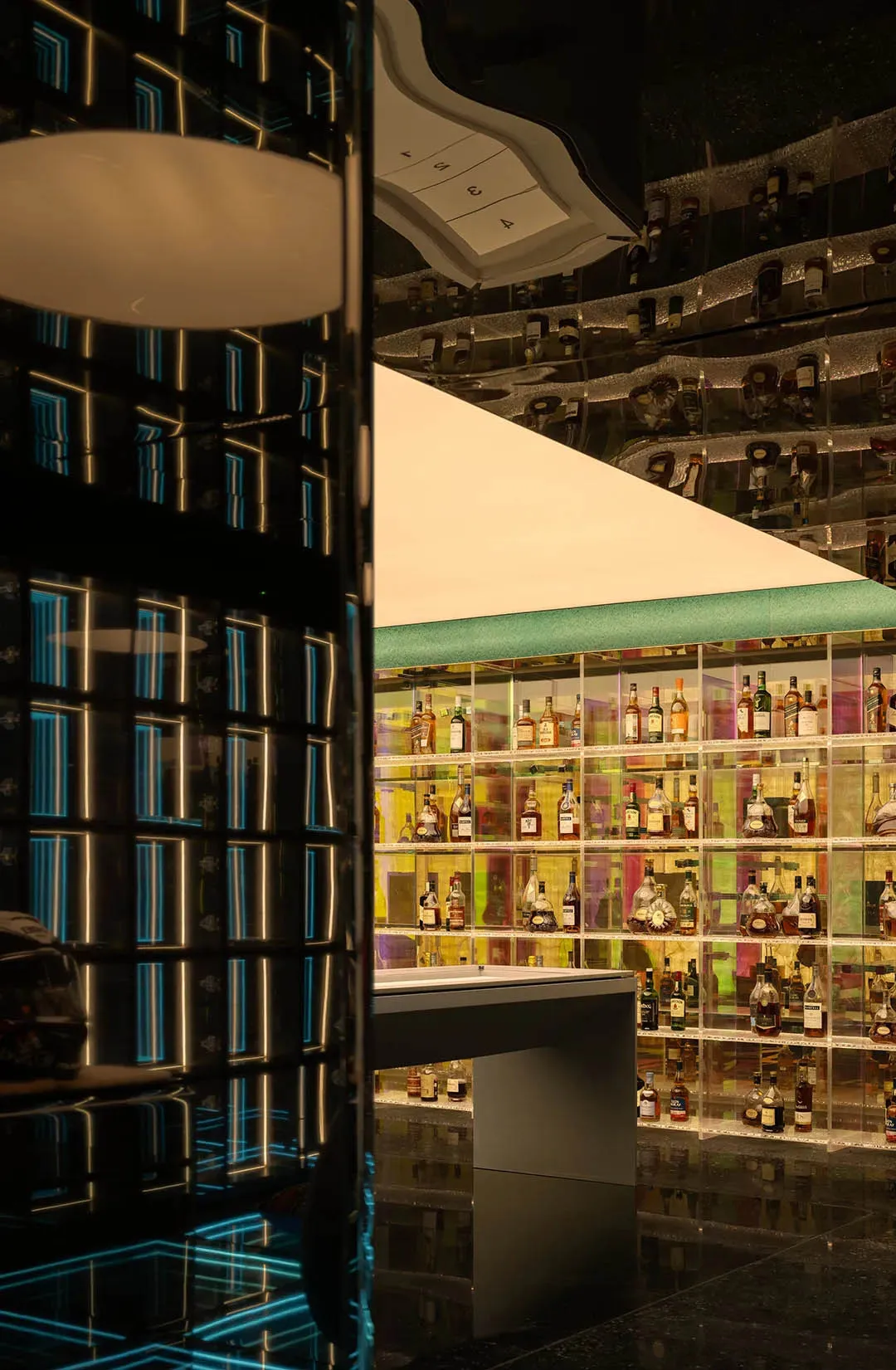 A well-lit bar filled with various liquor bottles on display, creating a visually appealing arrangement in a cozy and inviting atmosphere