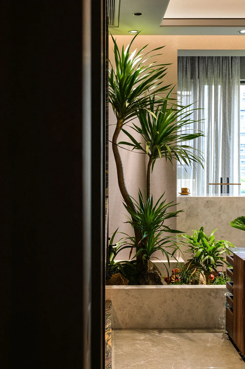 A clean and well-organized bathroom with potted plants and decorative vases, creating a relaxing ambiance