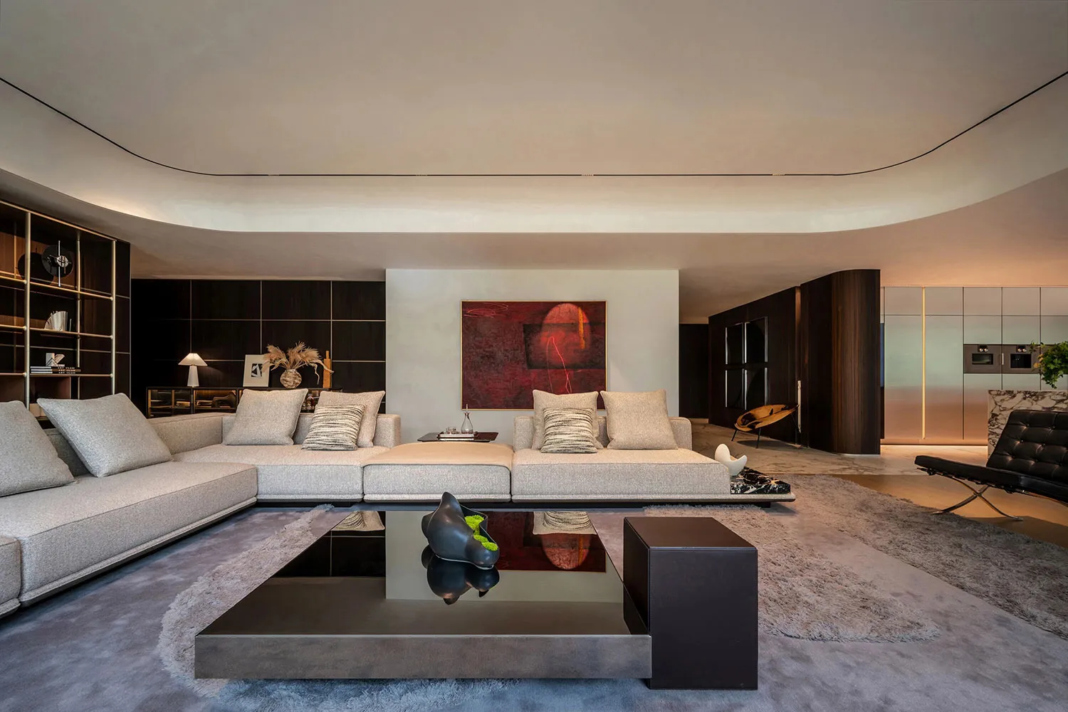 A modern living area with a large couch, two chairs, and decorative vases, creating a comfortable and inviting atmosphere
