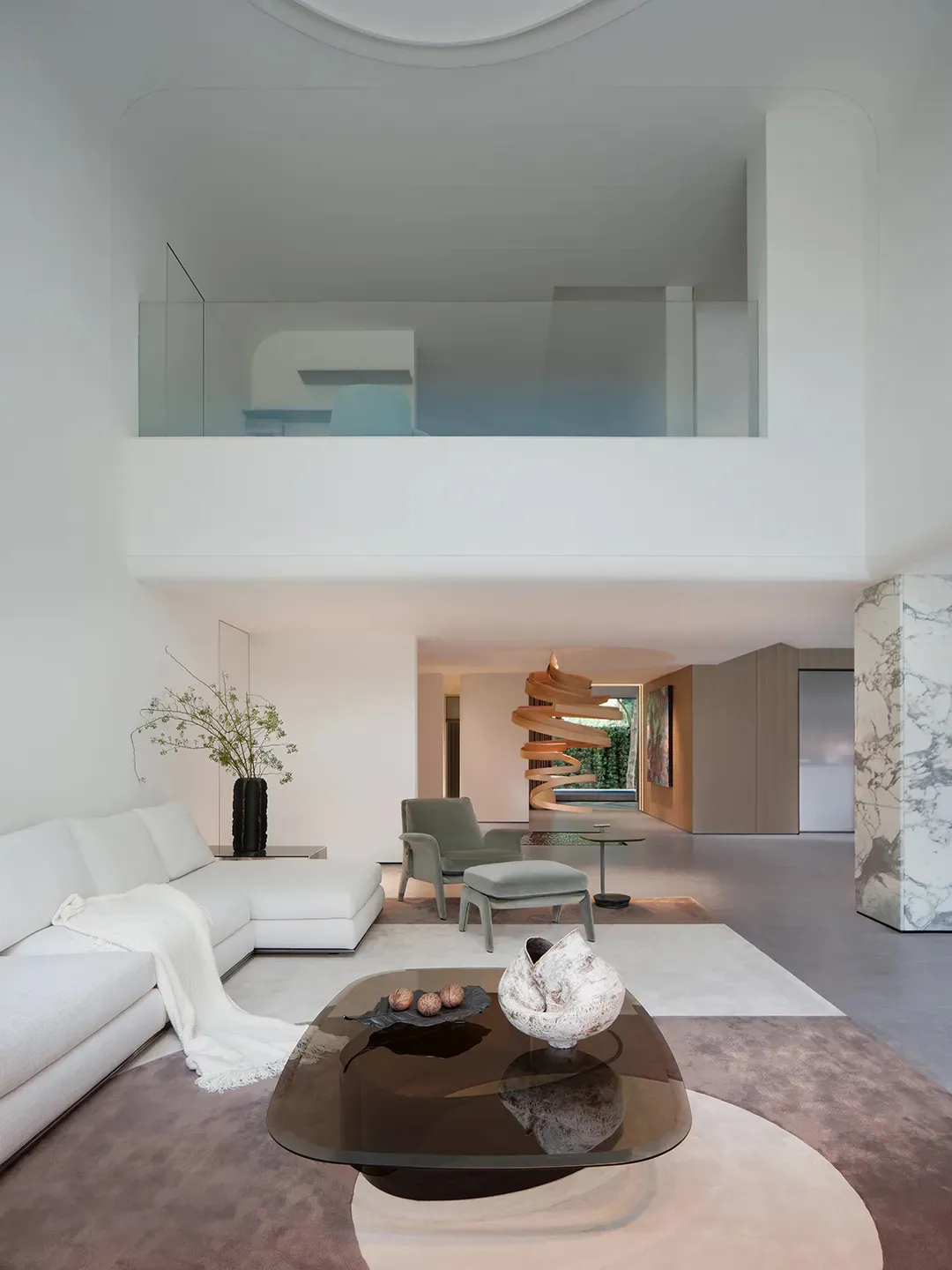 Open living space with a white couch, smaller couch, chairs, dining table, potted plants, and decorative vases in a clean and minimalist style with neutral tones