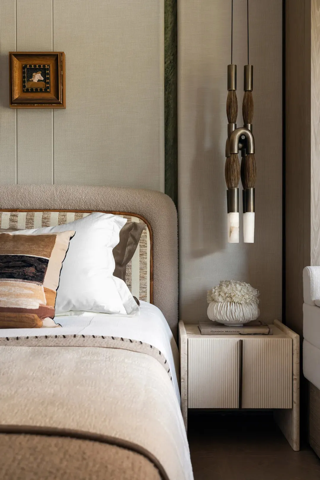 A cozy hotel bedroom with a large bed, white bedding, and wooden paneling on the walls