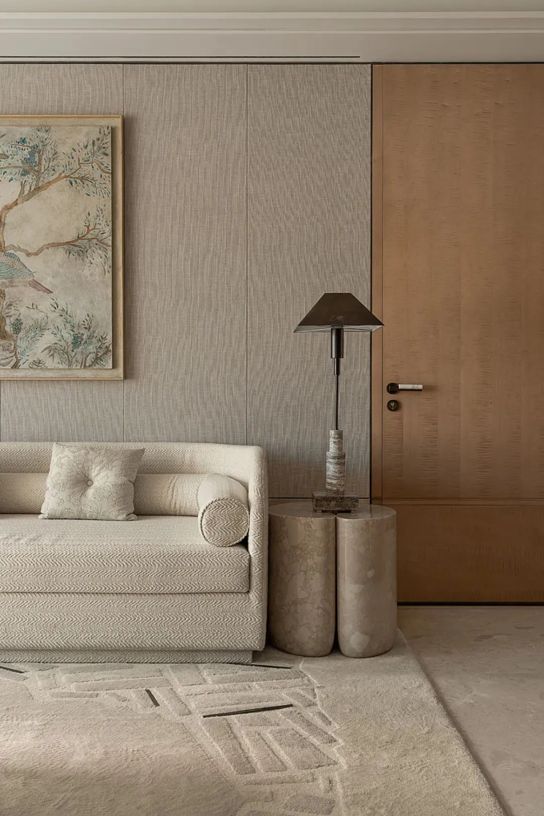 Cozy living area with a white couch, cream-colored walls, and two lamps on either side