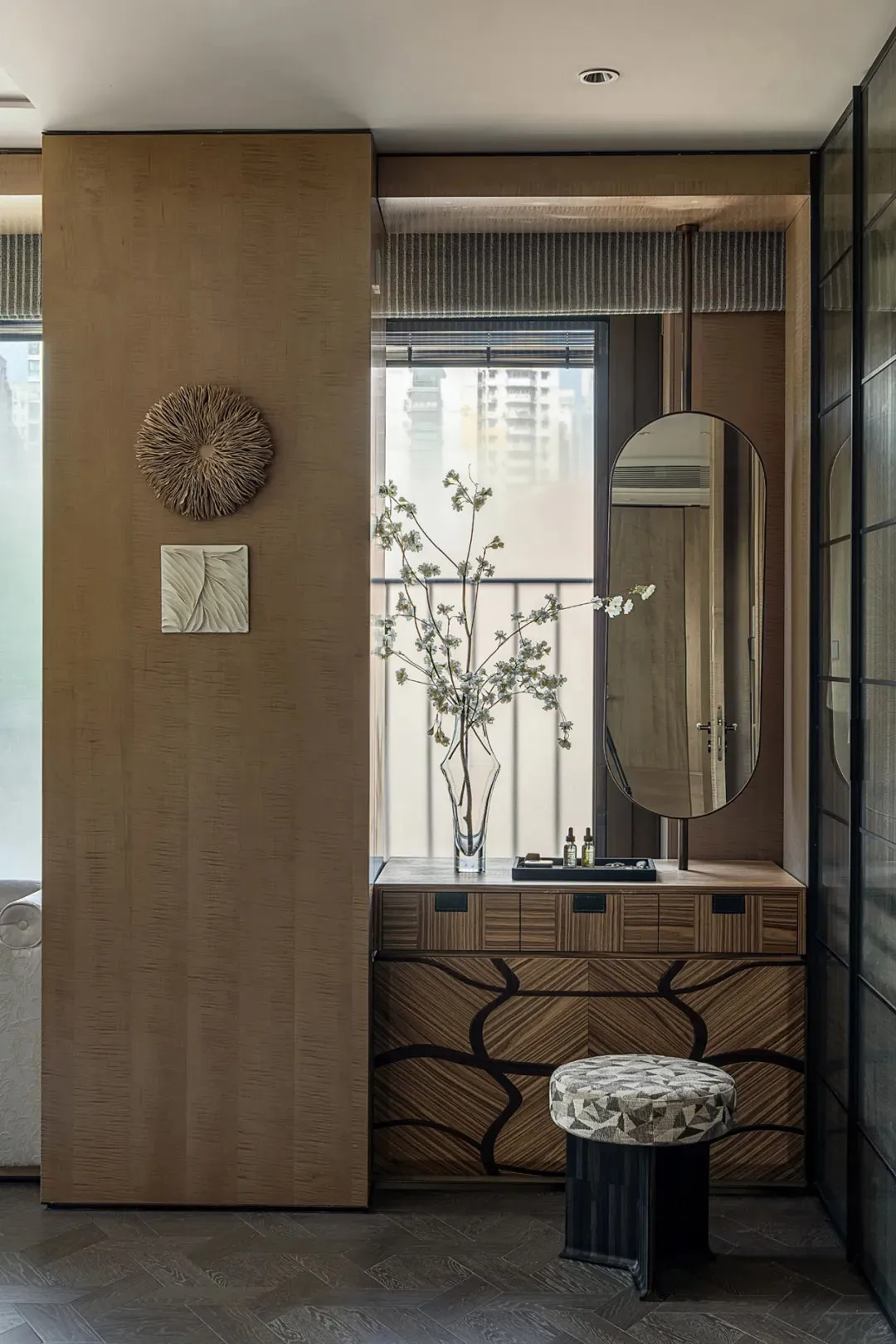 Well-lit bathroom with a large mirror, natural light, vases, a potted plant, and a clean inviting atmosphere