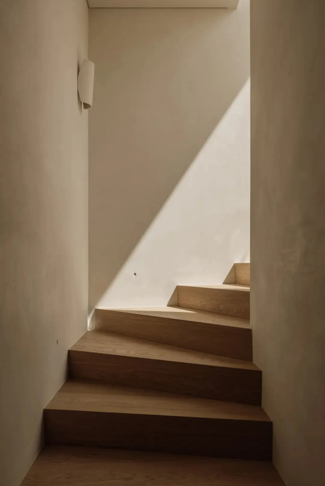 A classic staircase with two sets of wooden stairs, one on each side, in a historic building with a sense of nostalgia and charm