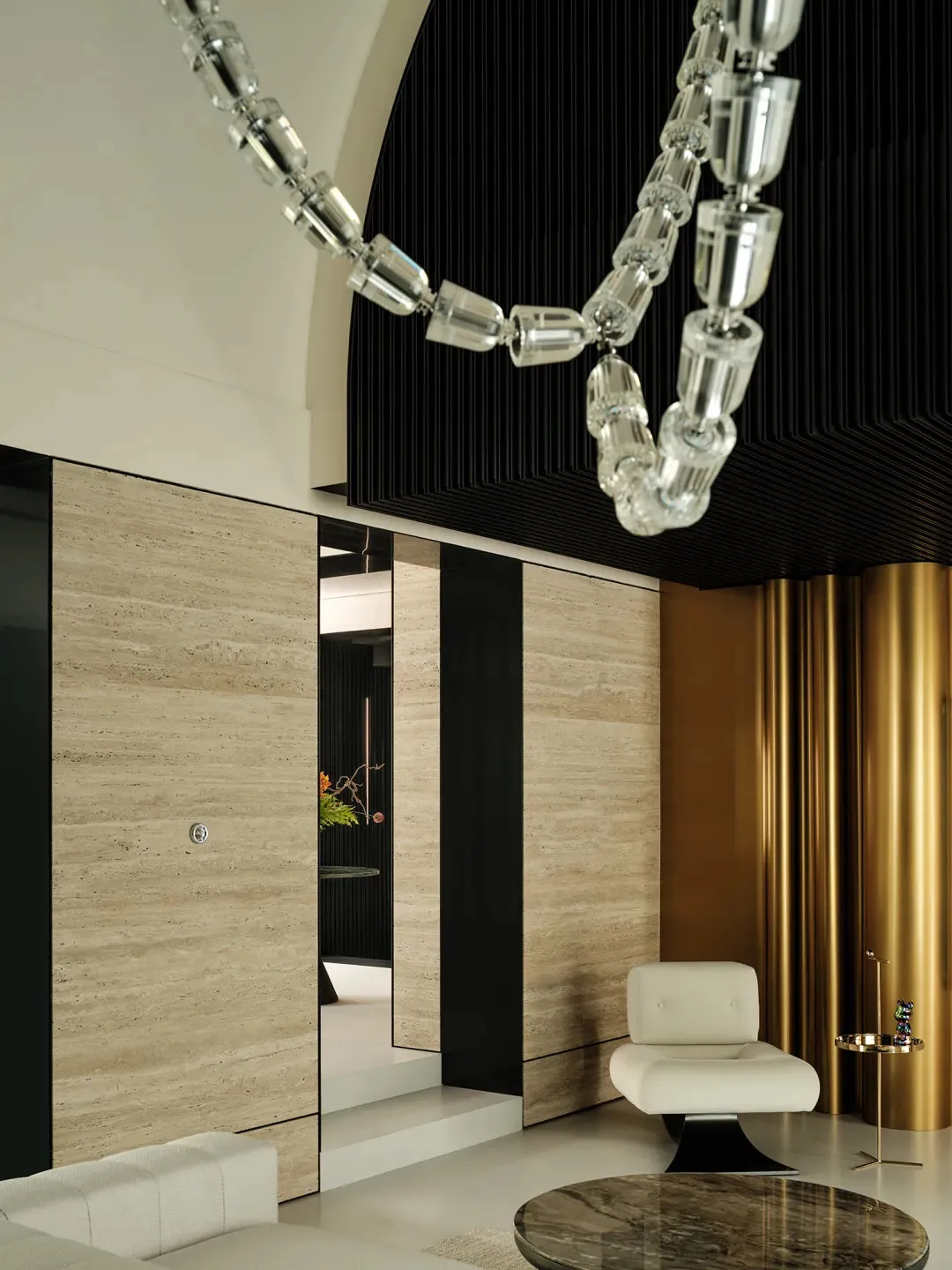 A luxurious living space with a leather chair, dining table, and mirror, set in a hotel suite