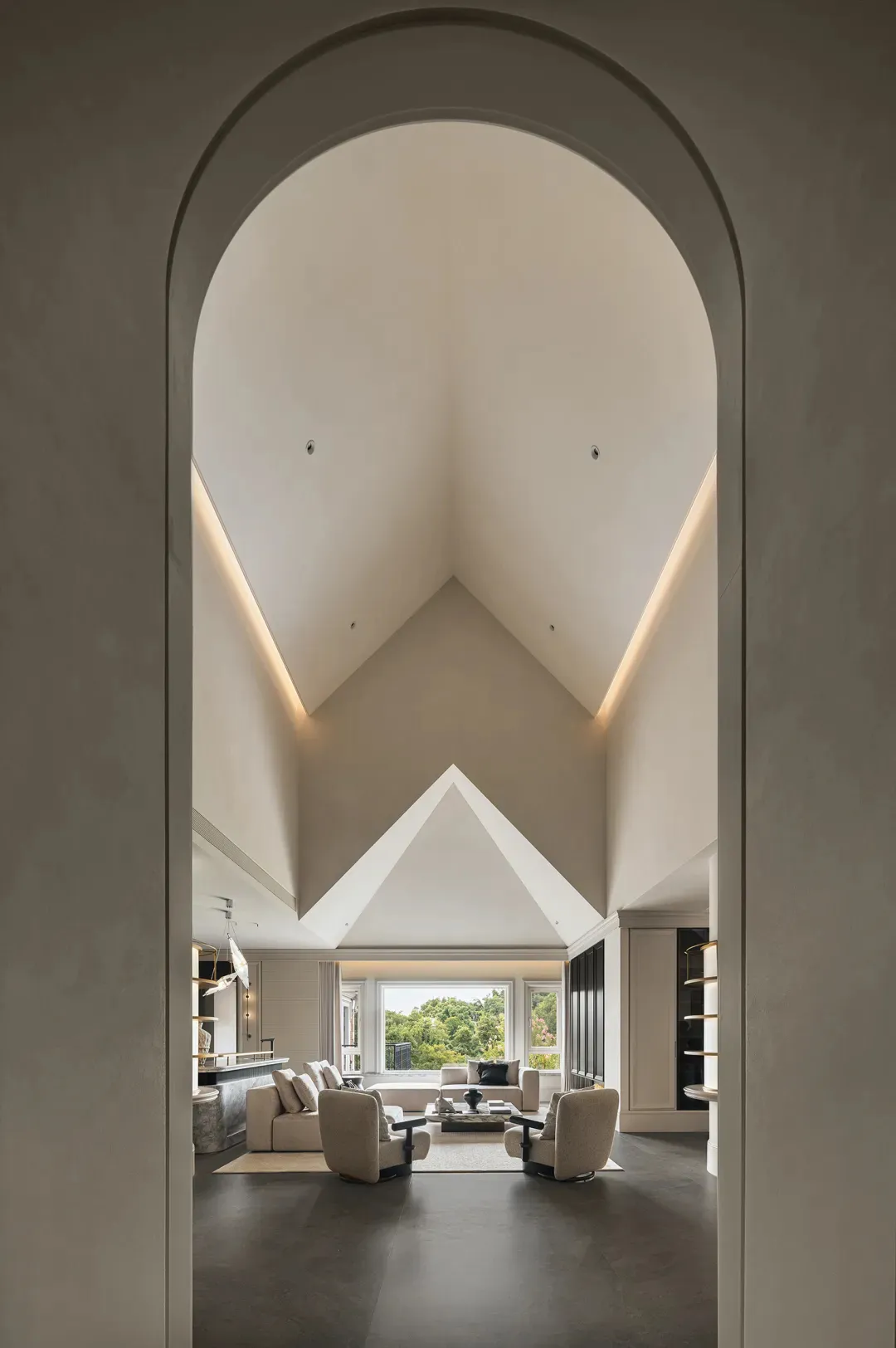 Open living and dining area with vaulted ceiling, two couches, a chair, and a dining table with chairs